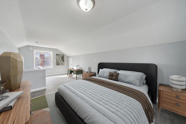 bedroom with baseboards and vaulted ceiling