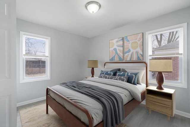 bedroom featuring baseboards and wood finished floors