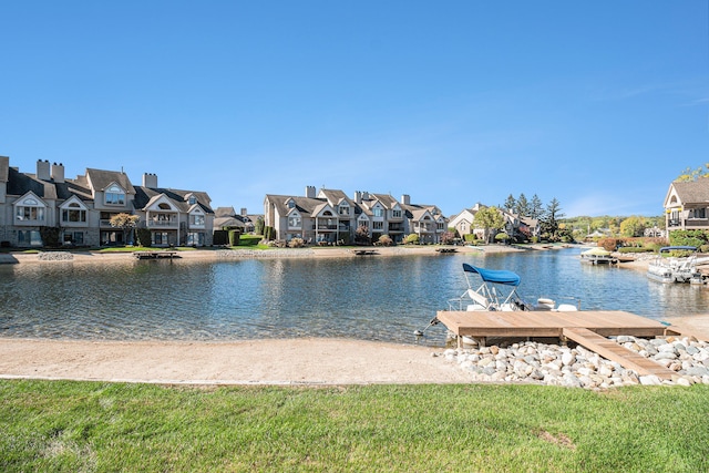 dock area with a residential view and a water view