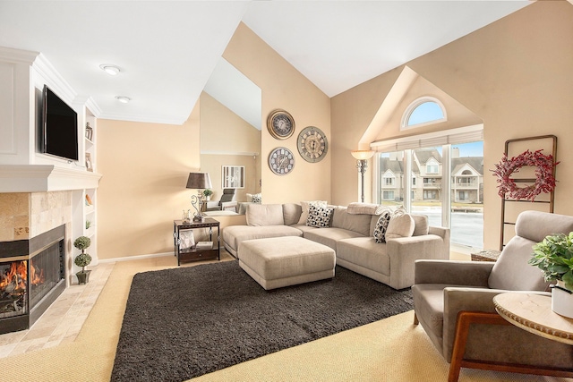 living area featuring a tile fireplace, high vaulted ceiling, and baseboards