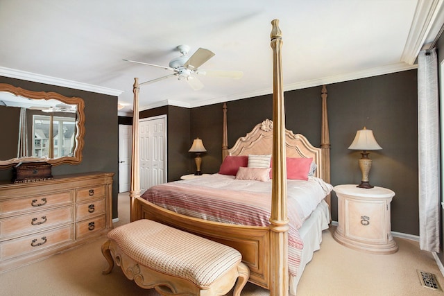 carpeted bedroom with a ceiling fan, visible vents, a closet, and ornamental molding