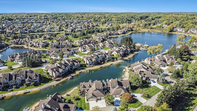 drone / aerial view featuring a residential view and a water view