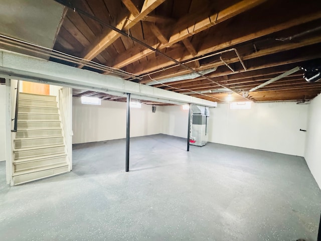 basement with stairs and water heater