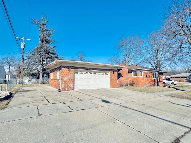 single story home featuring brick siding, fence, a chimney, driveway, and an attached garage