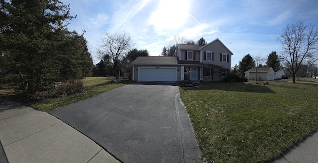 traditional-style house with a front yard, an attached garage, and driveway