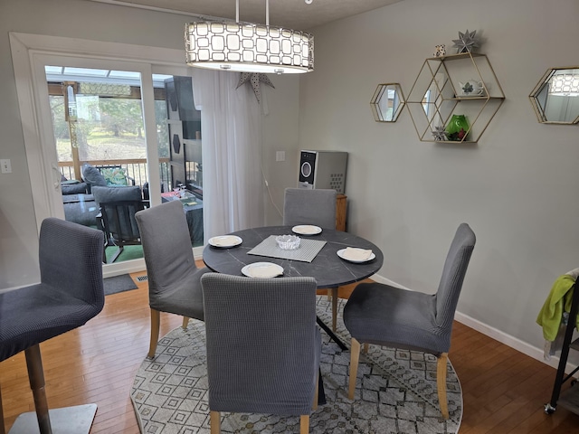 dining room featuring light wood-type flooring and baseboards