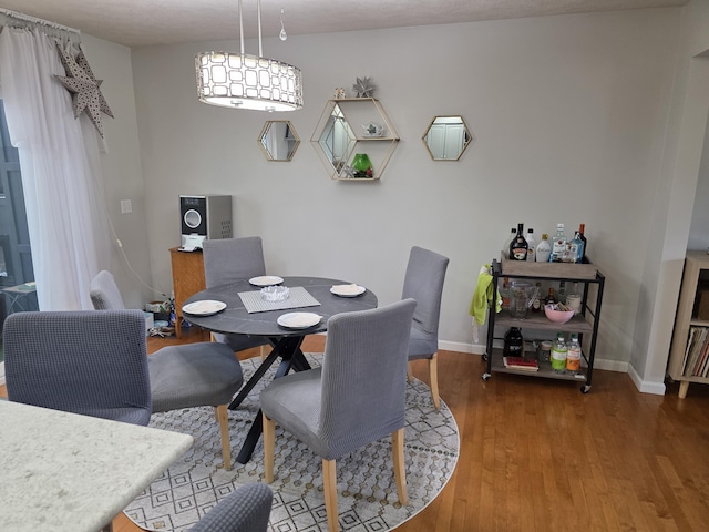 dining area with wood finished floors and baseboards