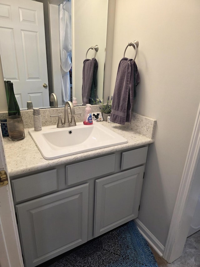 bathroom featuring baseboards and vanity