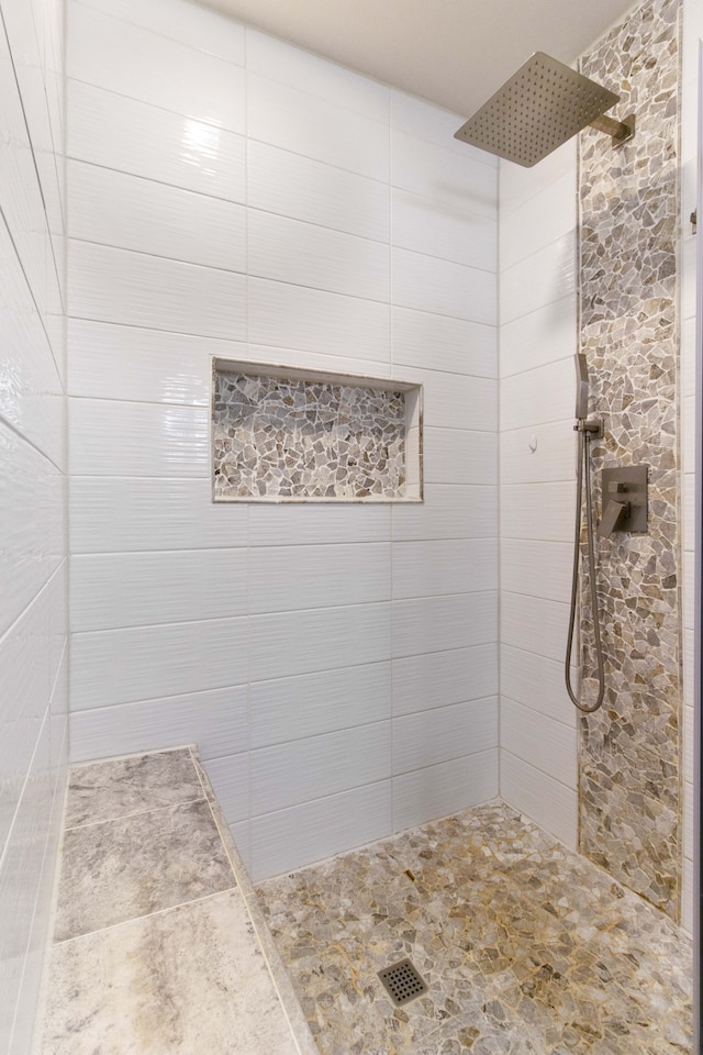 full bath featuring a tile shower