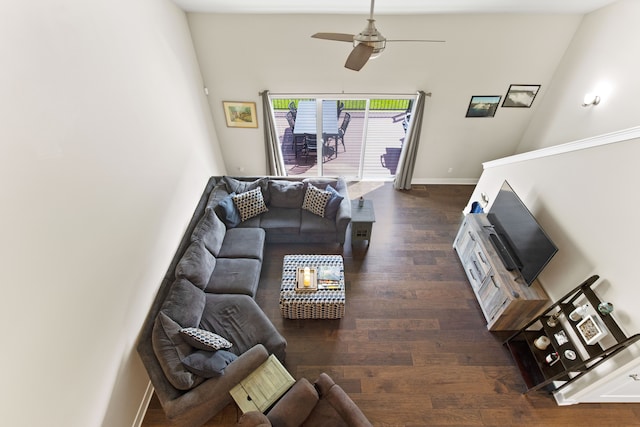 living area featuring dark wood finished floors, a ceiling fan, and baseboards