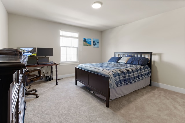 bedroom featuring baseboards and light colored carpet