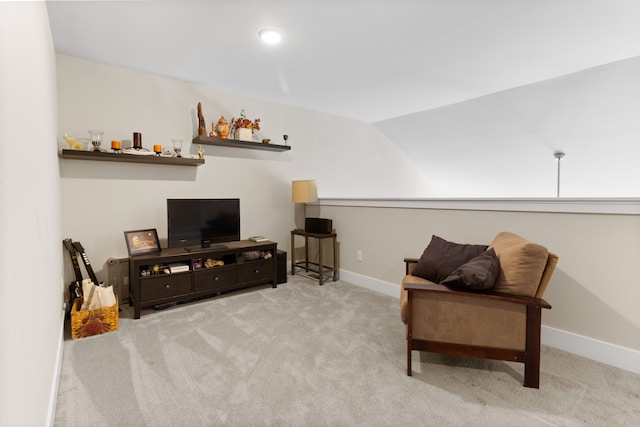 living area featuring vaulted ceiling, baseboards, and carpet floors