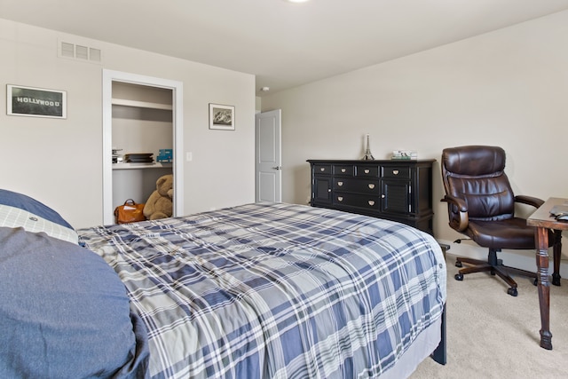 carpeted bedroom featuring visible vents