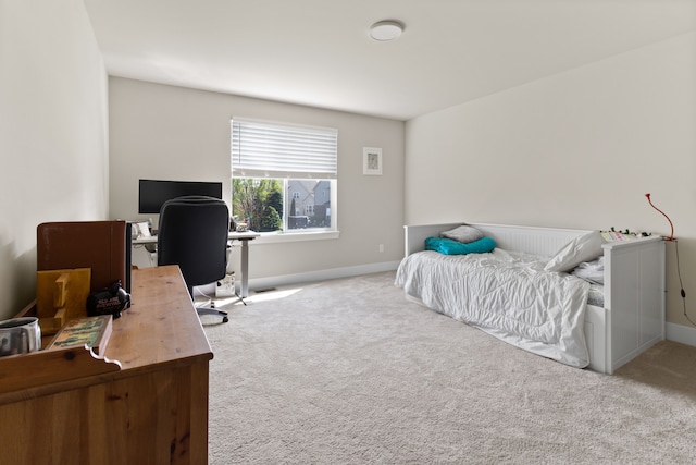 bedroom featuring baseboards and carpet floors