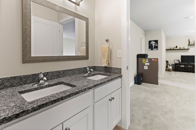 bathroom featuring a sink and double vanity