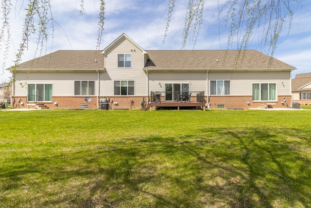 back of house featuring a deck, a yard, brick siding, and entry steps