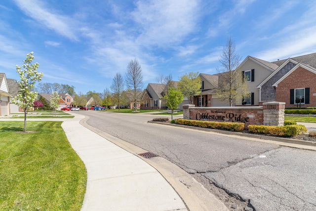 view of road with sidewalks, curbs, and a residential view