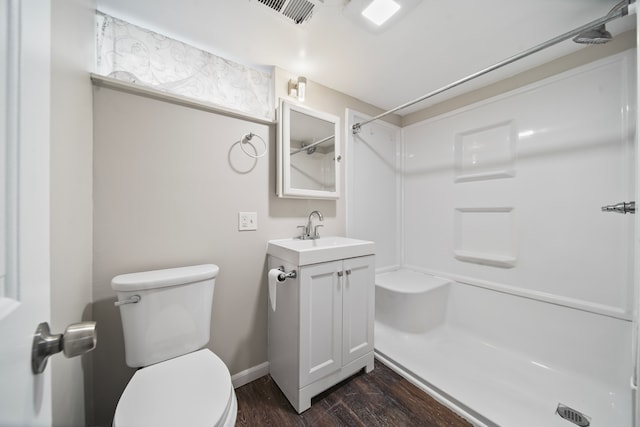 full bath with visible vents, walk in shower, toilet, wood finished floors, and vanity