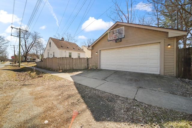 detached garage featuring fence