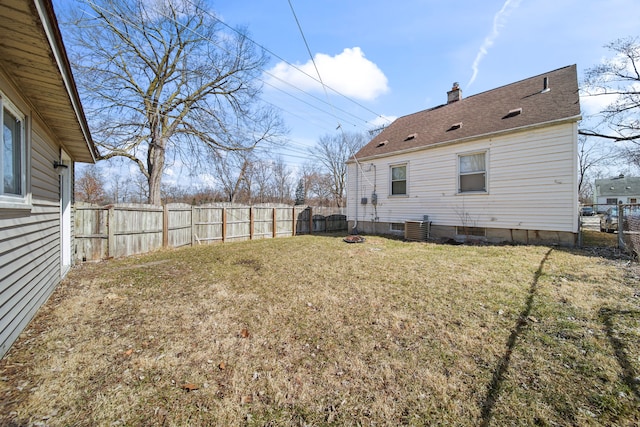 view of yard featuring central AC and a fenced backyard