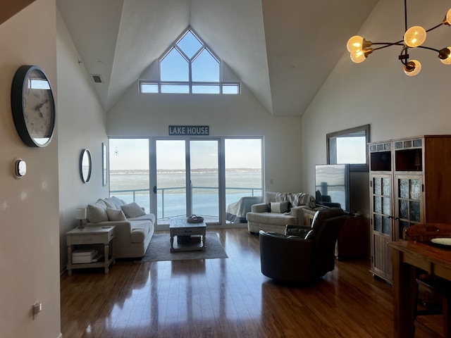 living room featuring plenty of natural light, wood finished floors, visible vents, and high vaulted ceiling