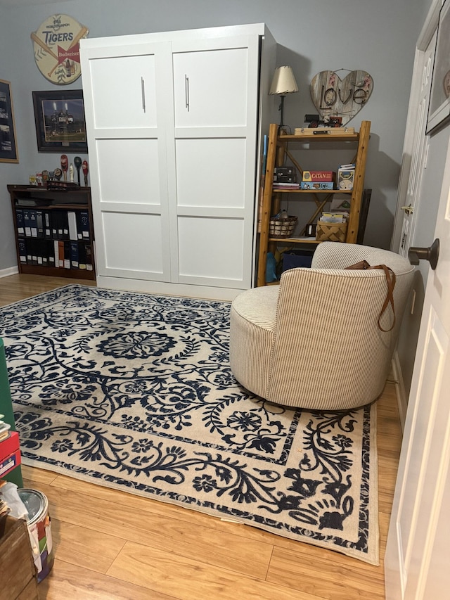 sitting room featuring wood finished floors and baseboards