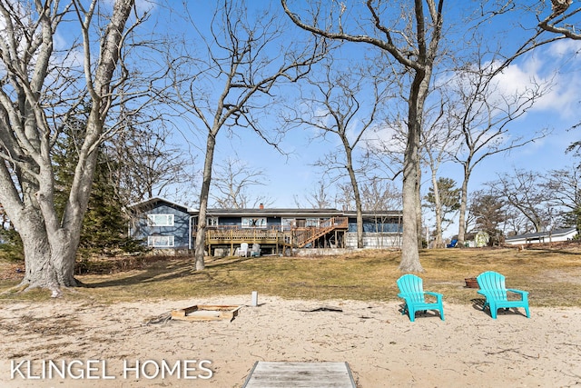 view of front facade with a deck and a front lawn