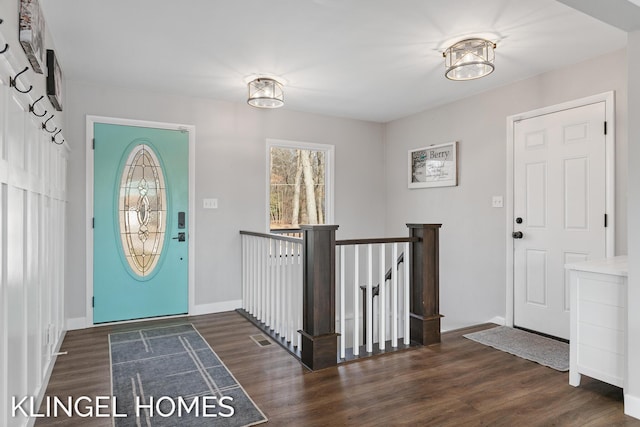 foyer featuring wood finished floors, visible vents, and baseboards