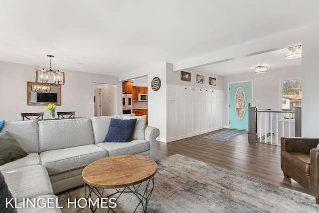 living room with a notable chandelier and wood finished floors