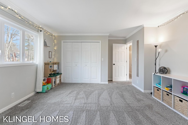 bedroom with a closet, carpet flooring, baseboards, and ornamental molding