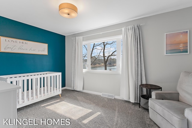 carpeted bedroom with visible vents, a crib, and baseboards