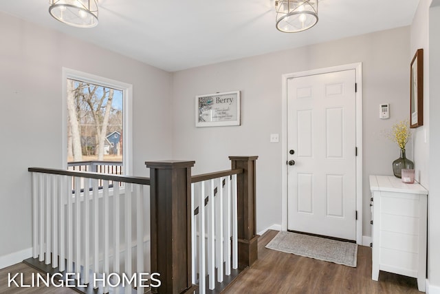 foyer featuring dark wood-type flooring and baseboards