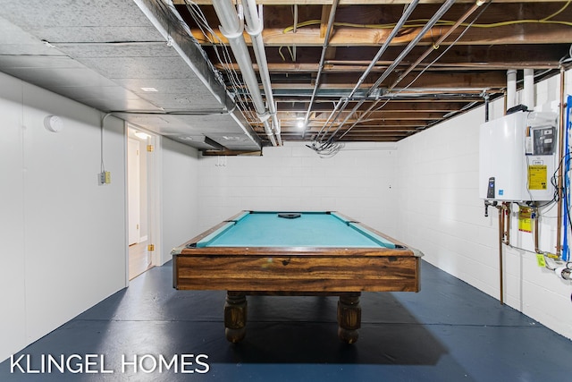 game room featuring water heater, concrete block wall, pool table, and concrete flooring