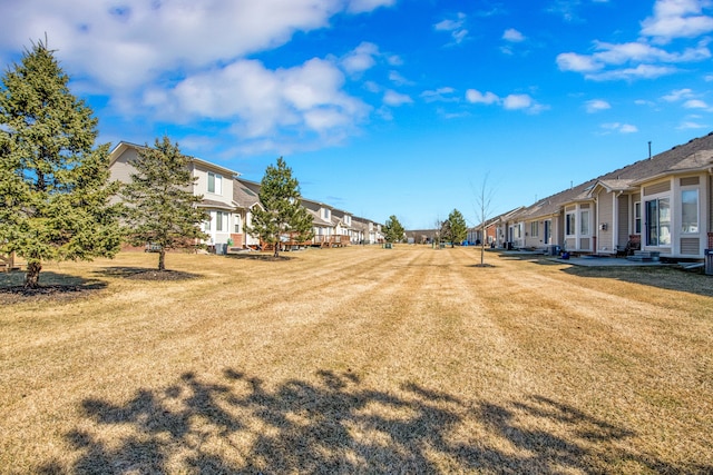 view of yard featuring a residential view and entry steps