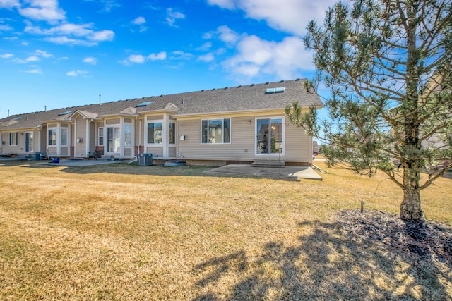 back of property featuring a patio, a lawn, a shingled roof, and entry steps