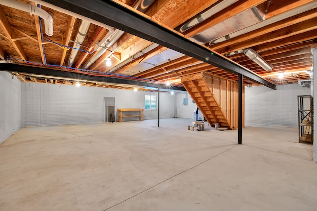 basement with brick wall and stairs