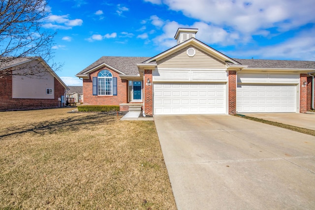 ranch-style house with a front yard, roof with shingles, an attached garage, concrete driveway, and brick siding