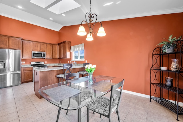 kitchen with an inviting chandelier, appliances with stainless steel finishes, brown cabinetry, crown molding, and light tile patterned floors