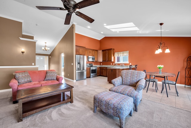 living area with light carpet, light tile patterned floors, ceiling fan with notable chandelier, and baseboards