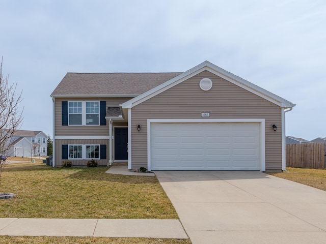 view of front of property featuring driveway, fence, roof with shingles, an attached garage, and a front yard