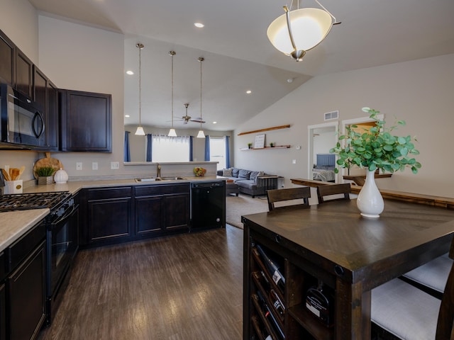 kitchen featuring visible vents, a sink, black appliances, light countertops, and dark wood-type flooring