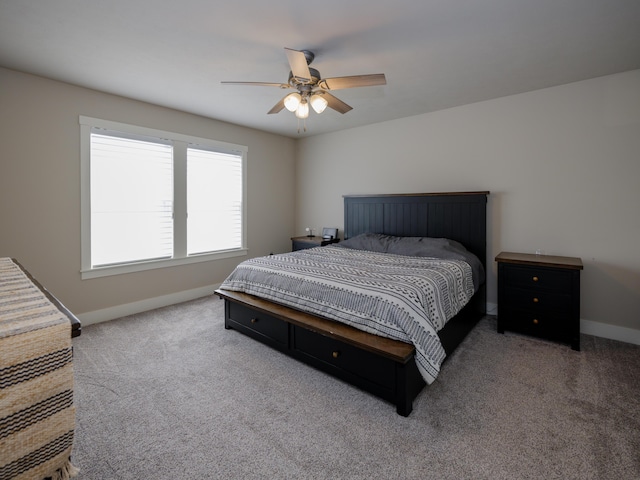 carpeted bedroom featuring baseboards and ceiling fan