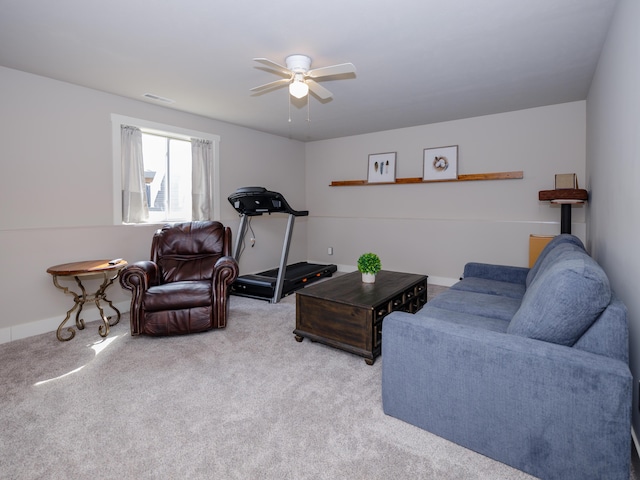 living area featuring carpet flooring, a ceiling fan, and visible vents