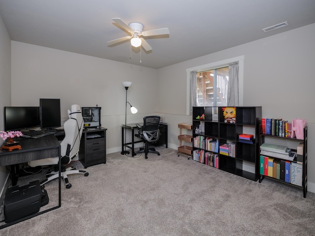 carpeted office featuring visible vents and a ceiling fan