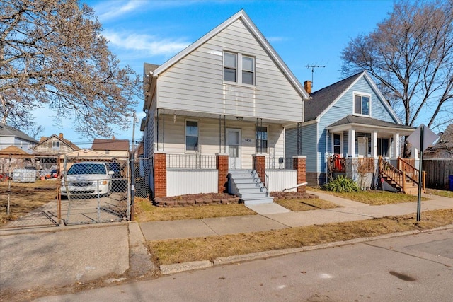 bungalow-style house featuring concrete driveway, fence, and covered porch