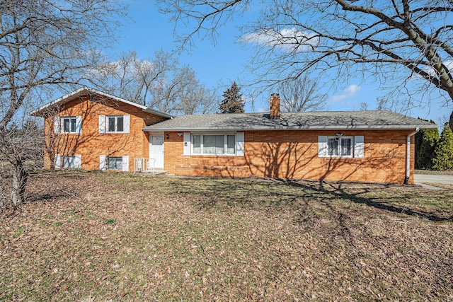 split level home with a chimney and a front yard
