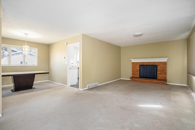 unfurnished living room featuring carpet flooring, a fireplace, baseboards, and visible vents