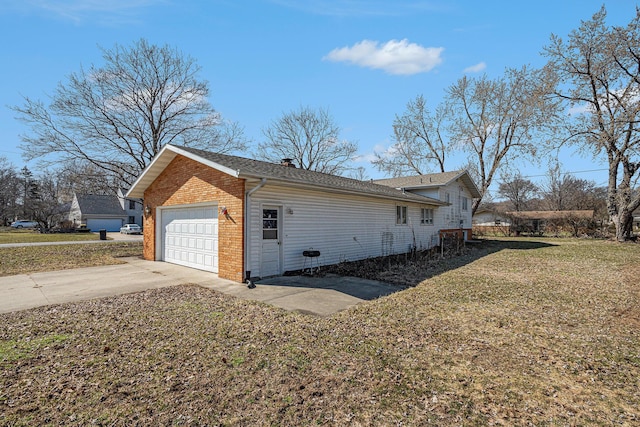 view of property exterior with a yard, brick siding, and driveway