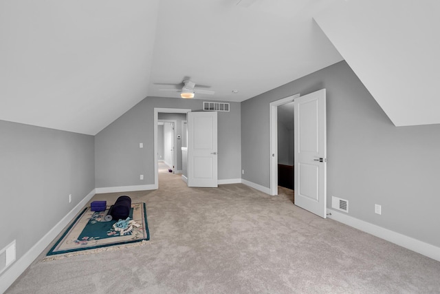 additional living space with visible vents, carpet flooring, and ceiling fan