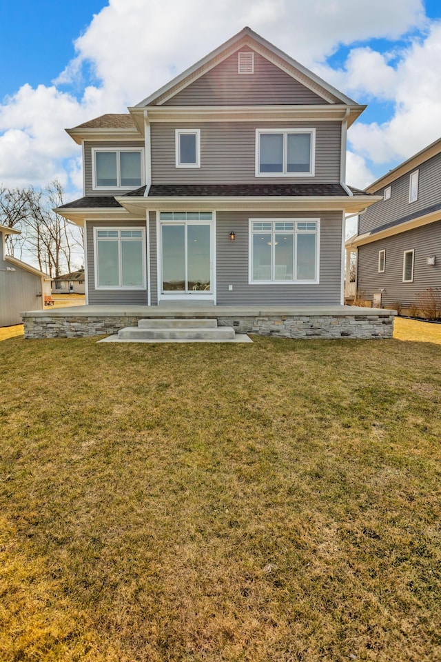 back of house featuring a patio and a lawn